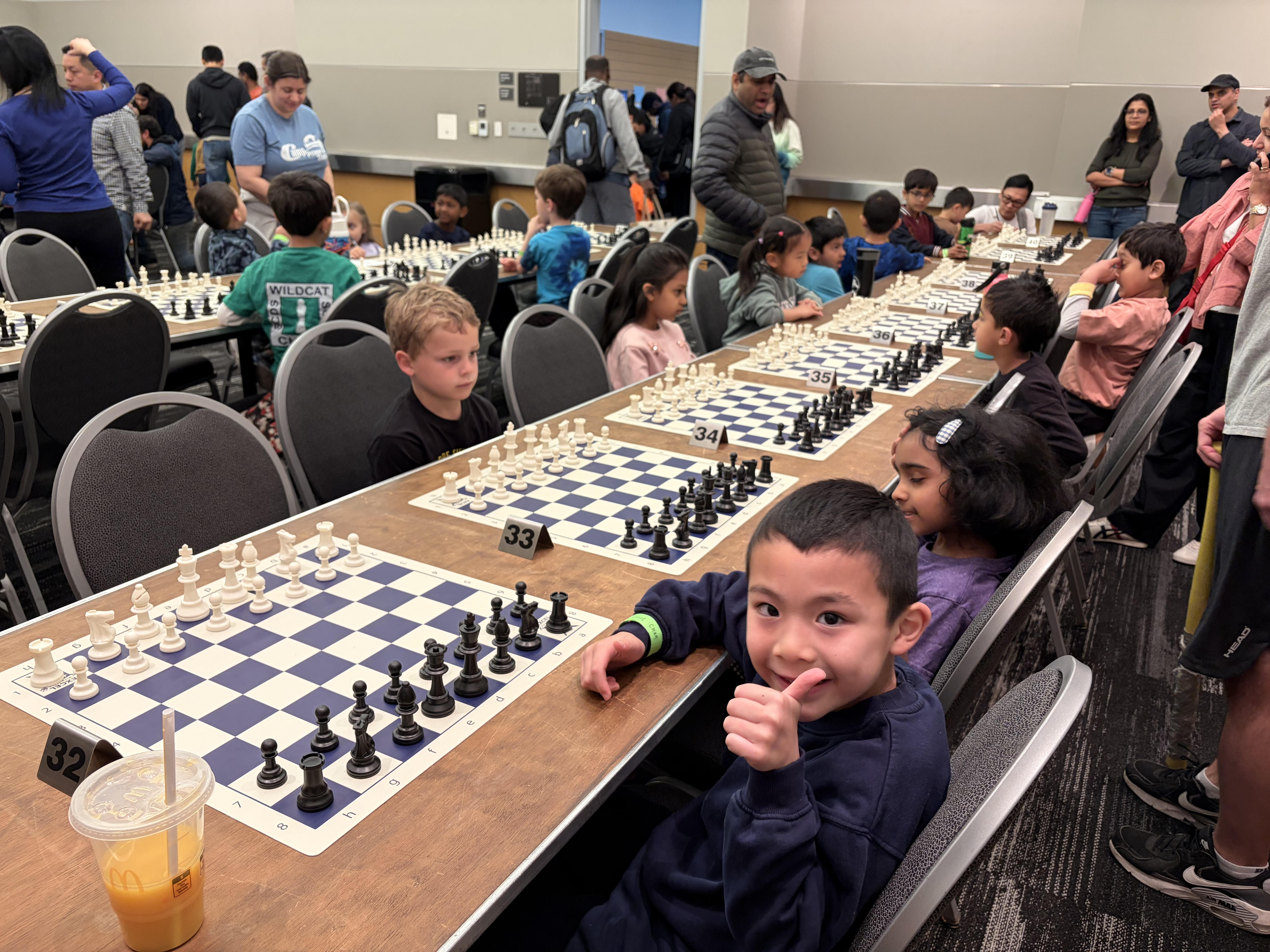 Elliot at the Washington State Scholastic Chess Championships, board 32, giving a thumbs up